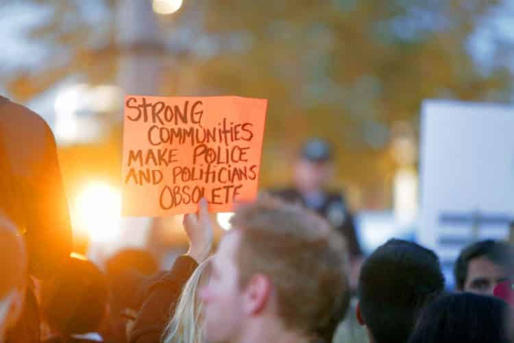 A photo of a protester with an orange placards
